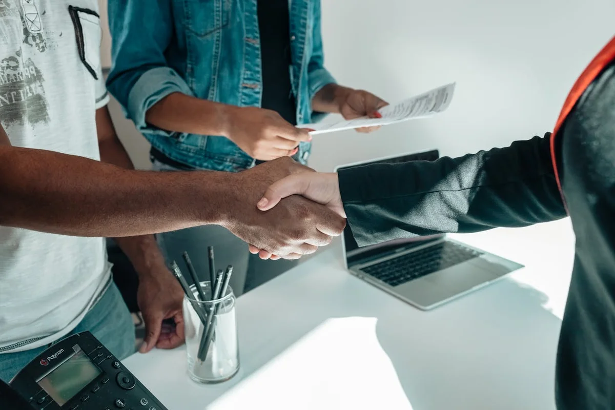 Business professionals shaking hands over an agreement