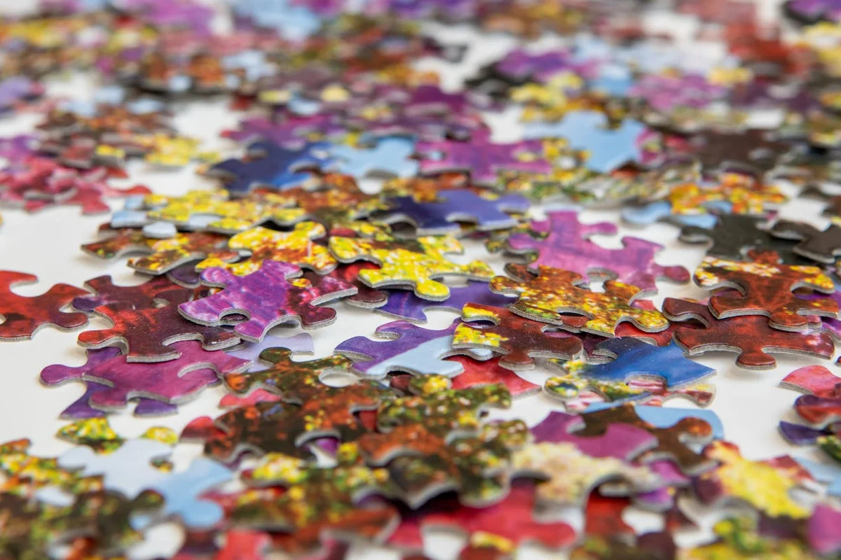 Scattered puzzle pieces representing content broken into fragments