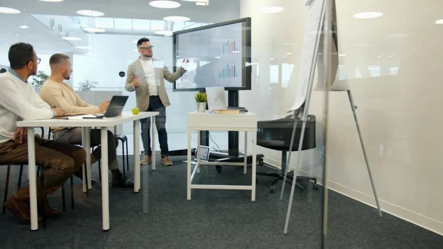 Team reviewing customer advocacy data on a screen in a modern office