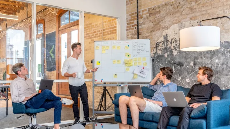 Professionals analyzing customer program performance in a modern office